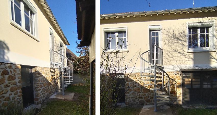 TORONTO spiralno stubište – kompaktno vanjsko rješenje za kuće s povišenim ulazom spiralno metalno stubište TORONTO montirano na stražnjoj strani obiteljske kuće s kamenim zidovima