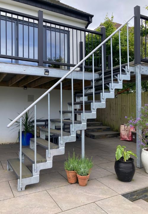 Vanjske stepenice DOLLE GARDENTOP Trimax® s kompozitnim gazištima vode s terase u vrt uz modernu obiteljsku kuću
